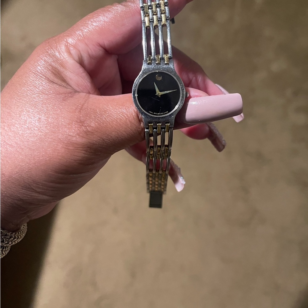 Movado Silver and Gold Watch with Black Face.